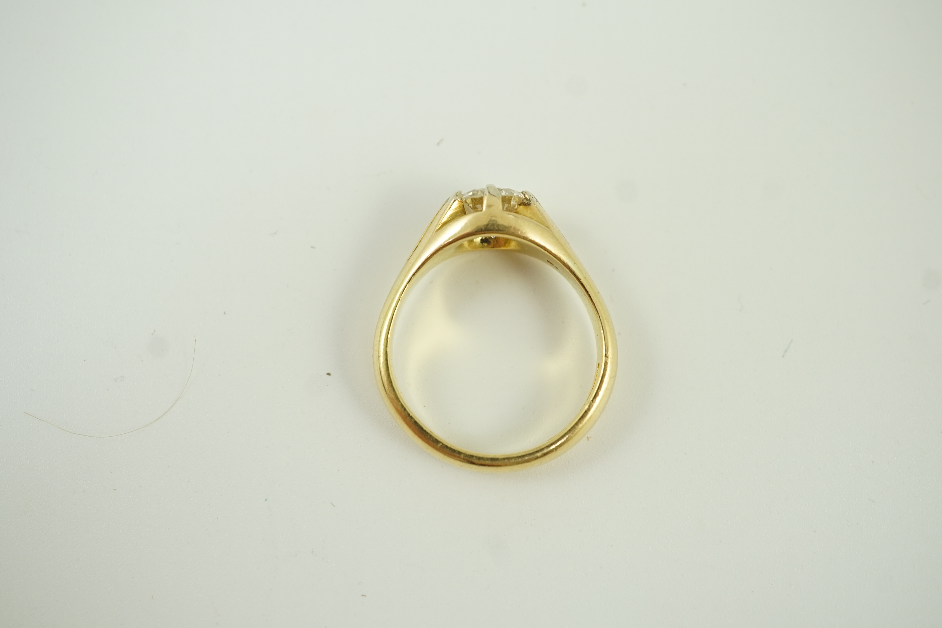 A modern 18ct gold and claw set solitaire diamond ring